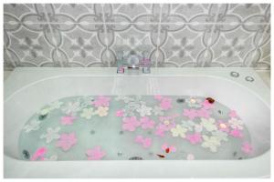 a bath tub with flowers painted on it at 1Bed Apt- Sleeps 6 City Center Jacuzzi Bath Wifi in Bradford