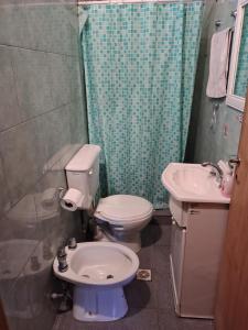 a bathroom with a toilet and a sink at Cabañas Cumbre in La Porteña +20 photos