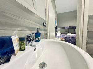 a bathroom sink with a faucet and a mirror at Angelia in Capaci +32 photos