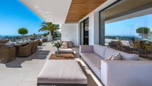 a living room with a couch and a table at VACATION MARBELLA I Villa Riviera The View, Luxury Villa, Breathtaking Sea View, Private Pool, Close Distance to the Finest Beaches in Sitio de Calahonda