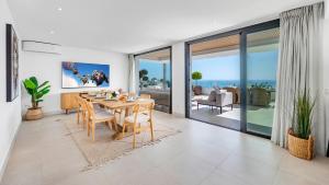a dining room with a table and views of the ocean at VACATION MARBELLA I Villa Riviera The View, Luxury Villa, Breathtaking Sea View, Private Pool, Close Distance to the Finest Beaches in Sitio de Calahonda