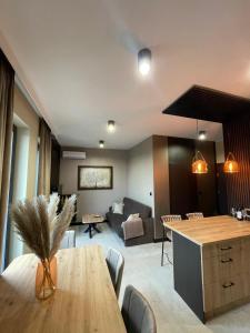 a kitchen and living room with a wooden table at Ludowa Apartment in Skorka