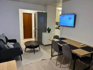 a living room with a dining room table and a tv at AWCompany Aps WORK & STAY-North Zealand Crew Accommodation in Tisvildeleje