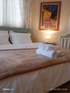 a hotel room with a bed with towels on it at CasaMamma in Drama