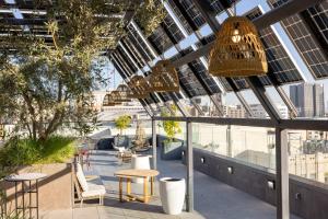 a rooftop patio with tables and chairs in a building at Whisky Hotel in Los Angeles