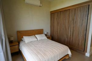 a bedroom with a bed and a large window at Hillside Oceanview Home with Pool in Venao in Playa Venao +15 photos