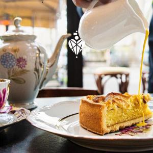 a person is pouring milk into a piece of cake at Biffi 2 - Garbatella Rooms in Rome