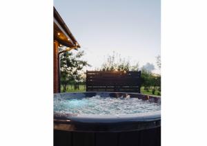 a hot tub with water in a yard at IKnamai in Sakiniai