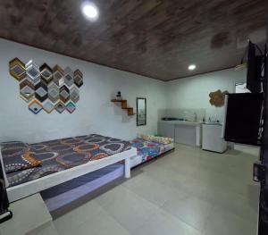 a bedroom with a bed and a tv in a room at Hospedaje Luz d' Luna in Puerto Triunfo