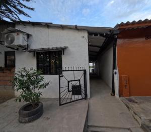 a building with a gate in front of a house at Hospedaje Luz d' Luna in Puerto Triunfo