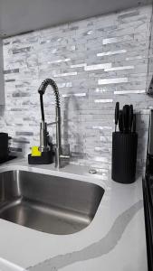 a kitchen counter with a sink and a sink at Contemporary Apartment- Prime Location to MBTA in Pawtucket