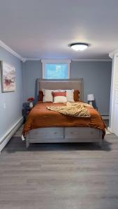 a bedroom with a large bed with blue walls at Contemporary Apartment- Prime Location to MBTA in Pawtucket