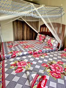 a bedroom with a bed with a canopy at African Dream Cottages - Diani Beach in Diani Beach