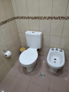 a bathroom with a toilet and a bidet at Mi Casa Tu Casa B , Departamento centrico in Lago Puelo +14 photos