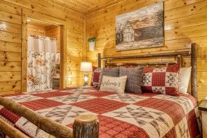 a bedroom with a bed in a log cabin at VIEWS! - Hot Tub - 3 Decks - Community Pool in Park Settlement