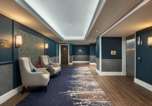 a hallway with chairs and a skylight at St. James' Court, A Taj Hotel, London in London