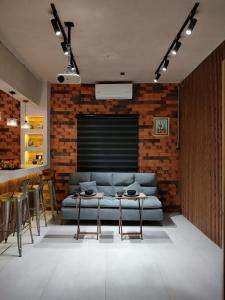 a living room with a couch and two tables at Amber Apartment at Downtown in Chihuahua