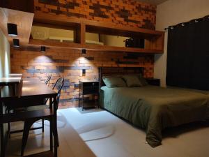 a bedroom with a bed and a table and a desk at Amber Apartment at Downtown in Chihuahua