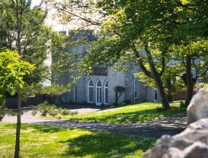 a house in the middle of a park with trees at Petralia BnB in Portland