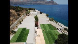 an aerial view of a walkway next to the ocean at Magic estate in the wave 2 in Kótronas +3 photos