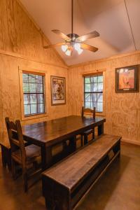 una sala da pranzo con tavolo in legno e ventilatore a soffitto di Frio Country #21 a Concan