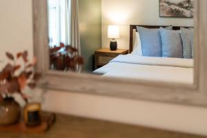 a reflection of a bedroom with a bed and a mirror at 5 King Beds - Sleeps 18 - Game Room - Brew Trail in Nellysford +70 photos