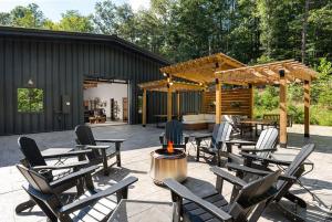 a patio with chairs and tables and a pavilion at 5 King Beds - Sleeps 18 - Game Room - Brew Trail in Nellysford