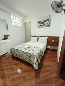 a bedroom with a bed with a table in it at Misky Puñuy in Chiclayo