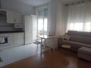 a living room with a couch and a table at Apartamento con gran terraza in San Vicente de la Barquera