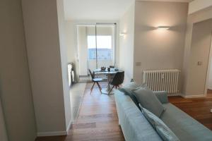a living room with a couch and a table at Aparthotel Isola in Milan