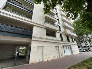 a white building with balconies on the side of it at Classy apartment with terrace in Saint-Ouen