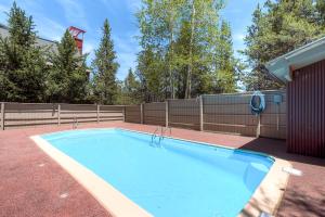a swimming pool in a yard with a fence at Ski Hill 15 by Ski Country Resorts in Breckenridge