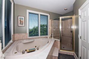 a large bathroom with a tub and a shower at Moonrise Point in Edisto Island +61 photos