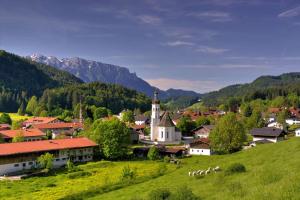 a small village with a church on a hill at ciao-aschau Grenzhub FeWo 208 Bär in Aschau