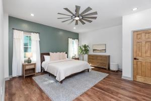 a bedroom with a bed and a ceiling fan at 5 King Beds - Sleeps 18 - Game Room - Brew Trail in Nellysford