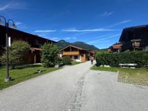 a person walking down a road in a village at ciao-aschau Grenzhub FeWo 308 Förster in Aschau