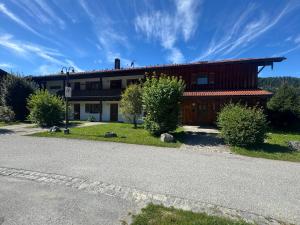 a building with a road in front of it at ciao-aschau Grenzhub FeWo 308 Förster in Aschau +9 photos