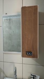 a window above a sink in a bathroom at A home away from home in Ijuí