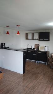 a kitchen with a counter top in a room at A home away from home in Ijuí