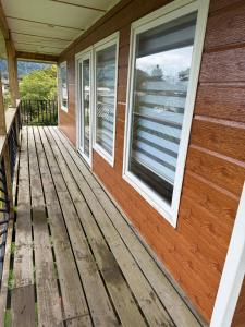 a front porch of a house with a window at Cabañas dunn in Puerto Cisnes