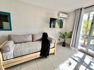 a bedroom with a couch with a scarf on it at Studio Conexión Mendoza WiFi rápido cerca del Parque San Martín y Av Arístides in Godoy Cruz