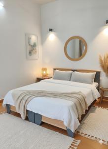 a bedroom with a large bed and a mirror at Navilehomestay in Candolim