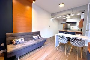 a living room with a couch and a table at Apto Design Moderno no Centro in Florianópolis +25 photos