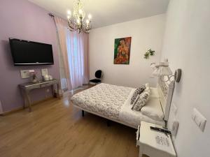 a small bedroom with a bed and a tv at Un Patio al Sur in Seville +73 photos