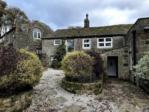 an old stone house with a stone driveway at The Bronte Moor Retreat - 3 Bed, Pet Friendly Cottage - Stunning Views - Hot Tub in Heptonstall +46 photos
