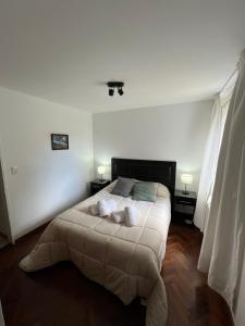 a bedroom with a bed with two pillows on it at Departamento Costa del Lago Bariloche in San Carlos de Bariloche
