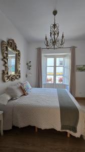 a bedroom with a large bed and a mirror at Un Patio al Sur in Seville