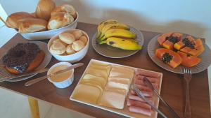 a table topped with plates of fruit and other foods at Pousada Contemplar Tiradentes in Tiradentes +13 photos