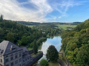 an aerial view of a building and a river at FeWo Panorama in Diemelsee