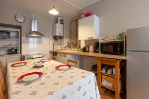 a kitchen with a table with red plates on it at Un T3 à 2 petits pas in Bagnères-de-Bigorre